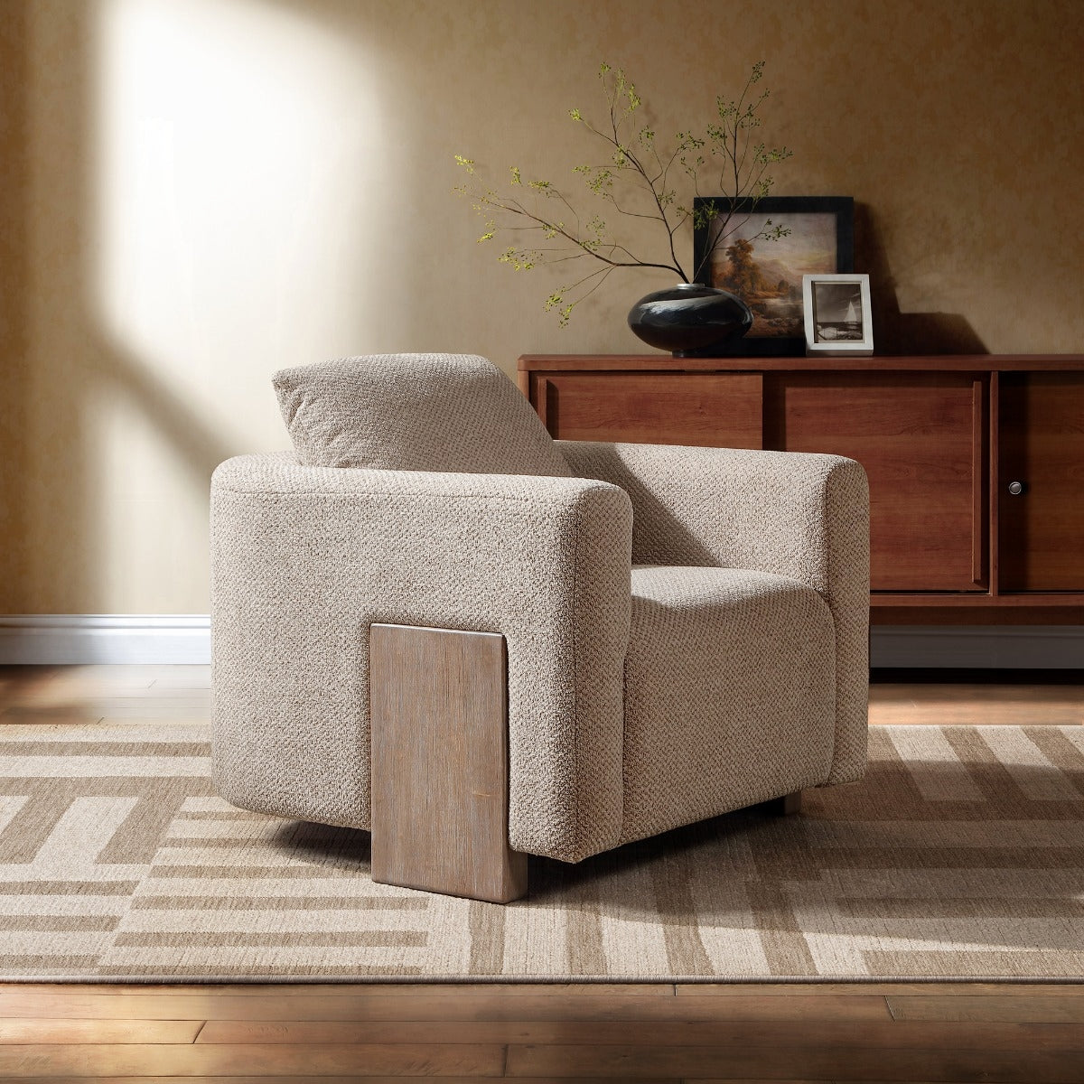 Arden latte linen accent chair with rounded arms and wood panel legs in a warm living room