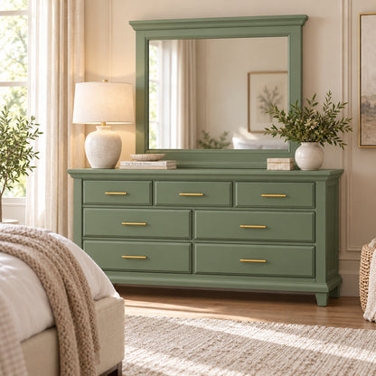 Sage muted green Bella seven-drawer dresser and framed mirror with slim gold-tone pulls in styled bedroom